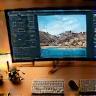 Editing desk with photography monitor displaying retouching work